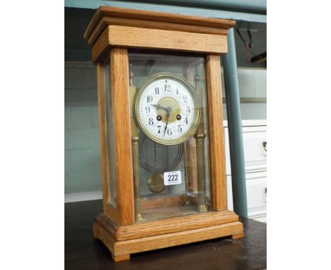 A late Victorian striking mantle clock in light oak and glazed case 