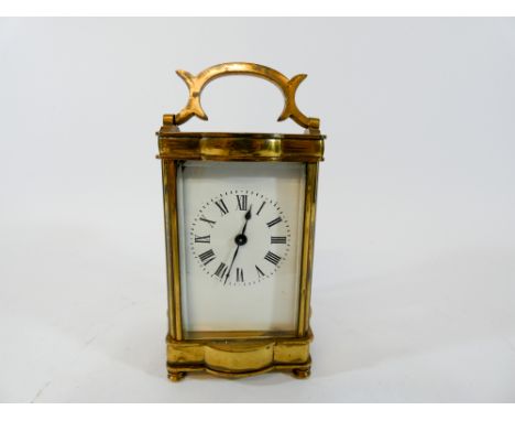 A gilt brass carriage clock with shaped case height with handle up 16cms 