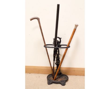 A Victorian iron stick stand, silver top walking cane,spear and a walking stick 