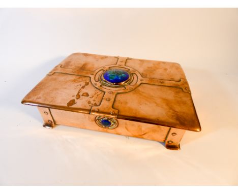 An Arts and Crafts copper and enamel box with oak lining. The copper box is decorated with strap work motifs and blue/green c