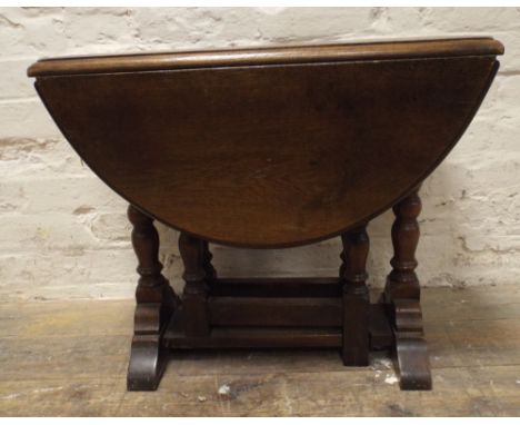 A reproduction oak swivel top gate leg style coffee table 