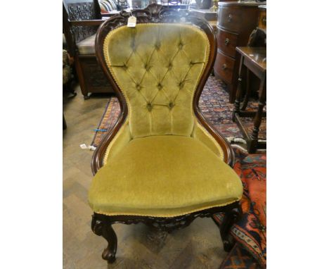 A Victorian walnut framed occasional chair standing on cabriole legs with green button back and upholstered seat  