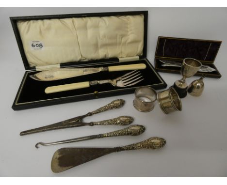 A collection of silver napkin rings, silver trophy cups, silver handled button hook and some silver plated cutlery in a box