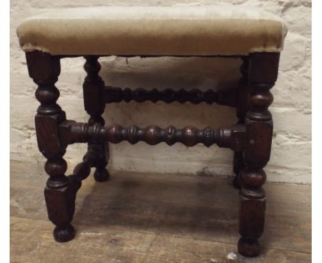A reproduction oak stool with bobbin turned legs and stretchers