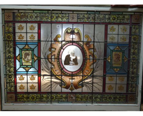 Three Victorian stain glass panels, the largest rectangular panel inset with a portrait of Sir John Tomesfrs with pair of mat