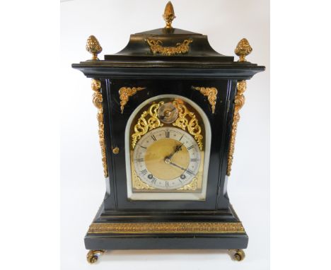 An early 18th Century style striking bracket clock with ting tang movement, a brass and silver arched dial contained in an eb