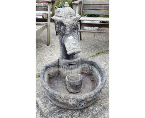 A reconstituted stone garden ornament of an old water pump with trough  