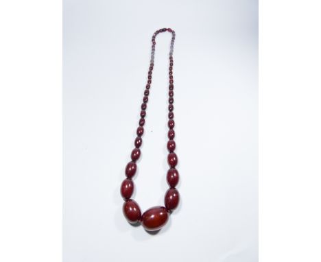 A long row of vintage red amber beads 