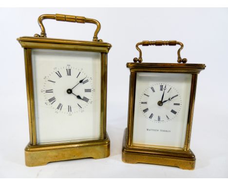 A small brass carriage clock by Matthew Norman together with a larger carriage clock (cracked dial) larger of clocks measures