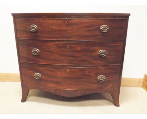 A Georgian mahogany bow front chest of three long drawers standing on splayed bracket feet, 39" wide x 34.5" tall  