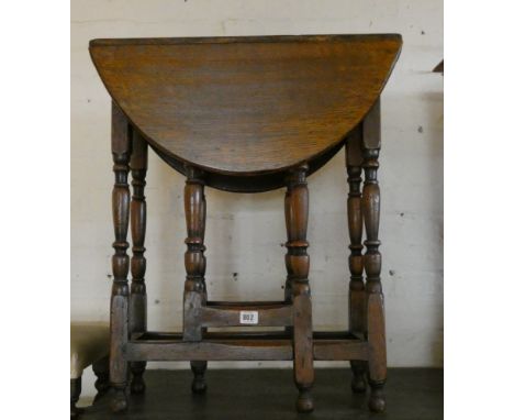 A late 19th early 20th century oval gate legged table on turned legs with cross stretchers, 2' wide 