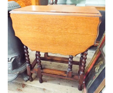 An oak gate leg table on barley twist legs with pie crust edge, 2'0 wide