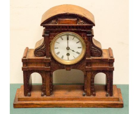 A mantle clock in oak Gothic building style case 
