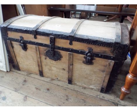 A metal bound, dome topped, pine trunk 