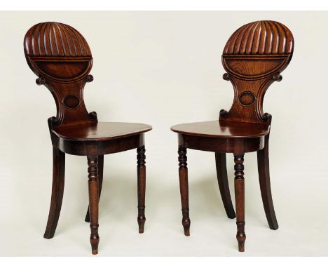 HALL CHAIRS, a pair, Regency mahogany with 'balloon' reeded and 'C' scroll backs, panel seats and turned front supports, 39cm