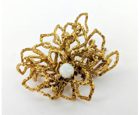 A YELLOW METAL ABSTRACT SPIDERS WEB BROOCH, set with a single opal cabouchon, early 20th century, 16.75 grams. 