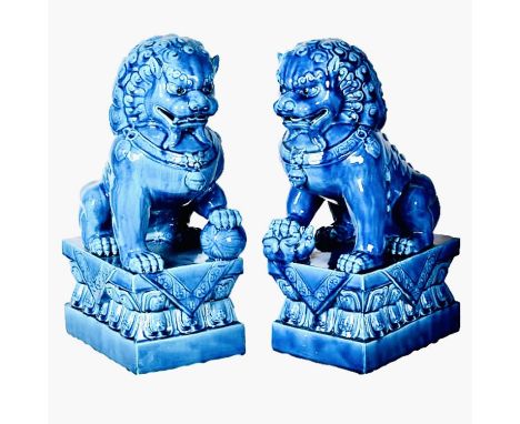 FOO DOGS, a pair, 40cm high, 15cm wide, 25cm deep, cobalt blue glazed ceramic. 