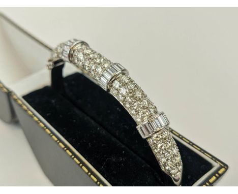 AN 18CT WHITE GOLD DIAMOND ENCRUSTED BANGLE, set with ninety round brilliant cut diamonds in four sections divided by diamond