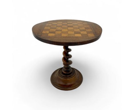 A 19thC miniature table, probably an apprentice's piece, the tilting oak top with chequered 'chessboard' oak and satinwood in