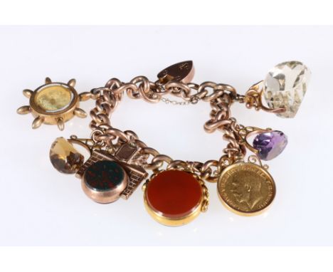 9ct gold charm bracelet set with a 1912 sovereign, four swivel fobs and a compass