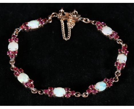18kt opal and ruby bracelet approx 8.2g   CONDITION REPORT:  No damages to bracelet.  All rubies present.  No signs of restor