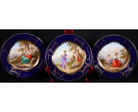 Three Vienna gilt porcelain cabinet plates, titled 'Amor am Pranger', 'Cupit von Euphrosine entruoiffnet' and 'Griselda', 24c