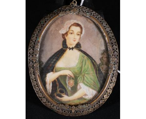 Portrait miniature on ivory of a woman in a clock holding up a portrait miniature in a gold frame, signed Ines **probably Ine