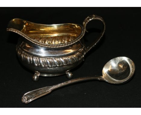 George IV silver cream jug raised on ball supports London 1823 JA approx 185g and a William IV silver ladle London 1832, appr