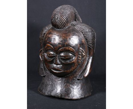 Punu style helmet mask with flattened, rounded face and elaborate ridged coiffure curving round the semi circular ears, pierc