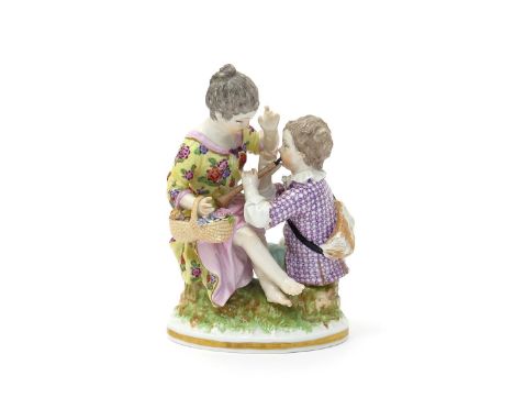 A Berlin figure group of children, late 18th century, modelled with a boy playing the flageolet, the girl seated on a stump a