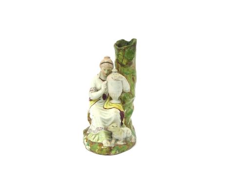 A pearlware spill vase group of Andromache weeping over the ashes of Hector, early 19th century, seated beneath a hollow tree