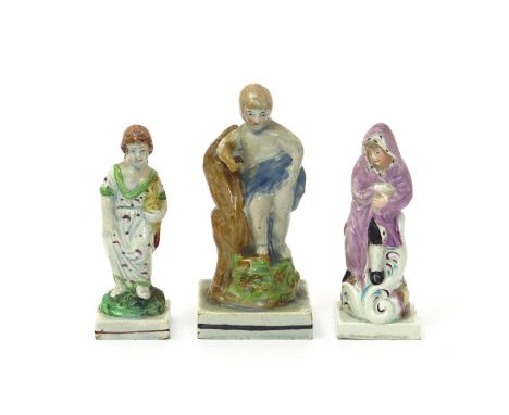 An unusual Staffordshire porcelain figure of Winter, late 18th century, modelled as a young boy huddled in a fur-lined cloak,