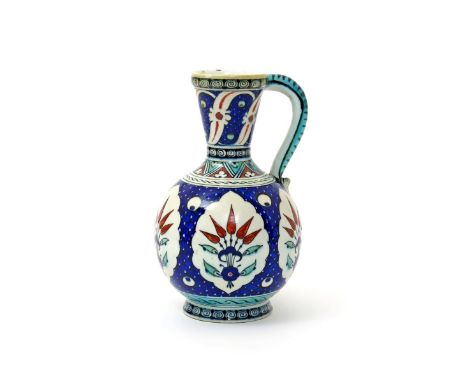 A Cantagalli Iznik-style ewer, late 19th/early 20th century, the ovoid body painted with panels of stylized flowerheads reser