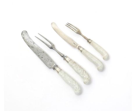 Two Chelsea knife handles and two forks, c.1752, with moulded pistol hafts, a two-pronged fork and knife applied with floweri