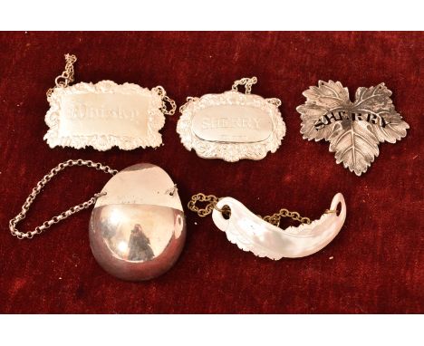 A collection of five decanter labels including a silver plate example and mother of pearl. H=7, W=5cm