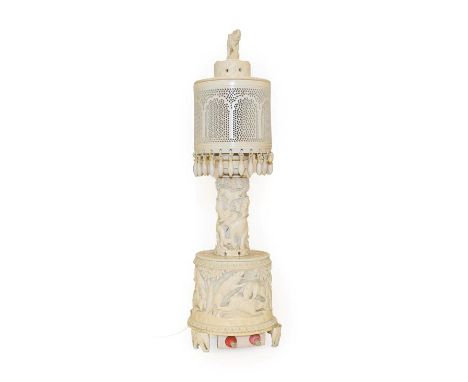 An Indian Ivory Lamp Base and Shade, 1920-30, with elephant finial, pierced cylindrical shade, and cylindrical stem and base 