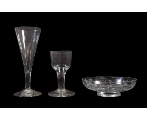 A Cordial Glass, circa 1770, the ogee bowl on a plain stem and circular foot, 10cm high; An Ale Flute, the drawn trumpet bowl