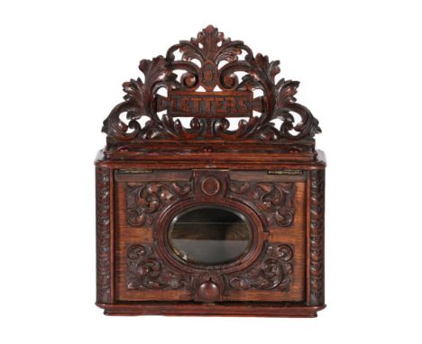 A Victorian Carved Oak Country House Letterbox, with scrolling oak leaf pierced cresting inscribed LETTERS over a rectangular