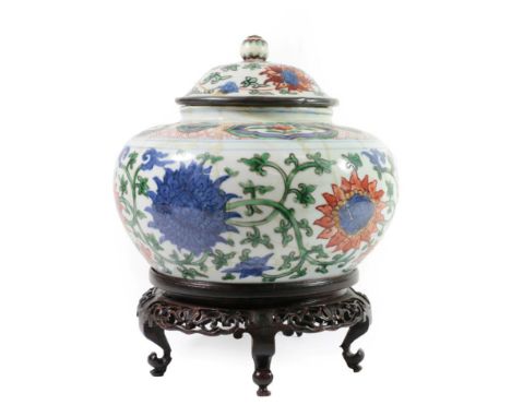 A Chinese Wucai Porcelain Jar and Matched Cover, in 17th century style, painted with bands of scrolling foliage within panel 