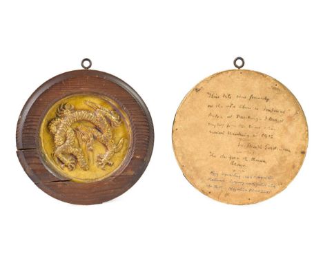 A Chinese Ochre Glazed Tile, probably Ming Dynasty, of circular form, moulded in relief with a sinuous dragon, 10cm diameter,