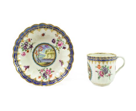 A Worcester Porcelain Fluted Coffee Cup and Saucer of Dalhousie Type, circa 1780, each painted with a landscape panel on a gr