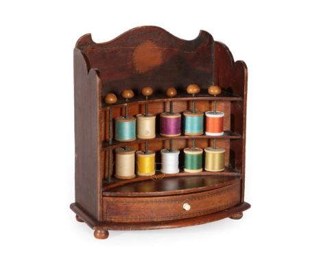 A Regency Stained Wood and Penwork Bobbin Stand, with arched cresting over three reverse bowfront shelves with metal spindles