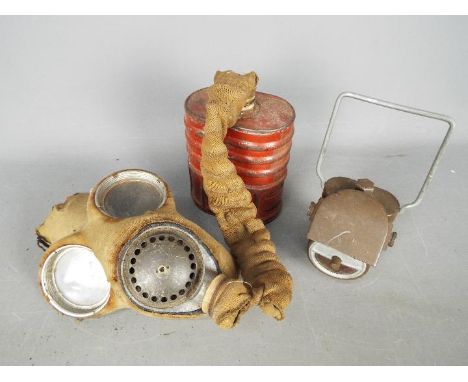 A World War Two (WWII) gas mask 4A by Barringer, Wallis &amp; Manners Limited, 1940 and a Joseph Lucas Ltd 'Lamp Electric No.