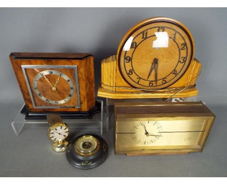 Three mantel clocks, a barometer and a desk thermometer.