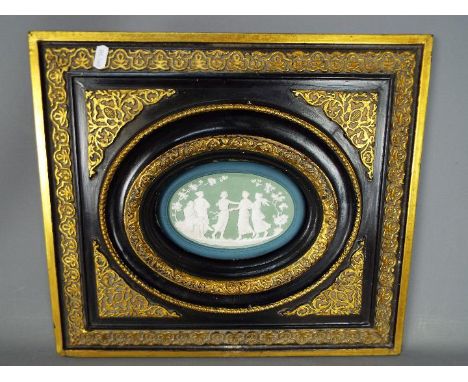 A framed Victorian oval tile, approx frame size 38 cm x 42 cm 