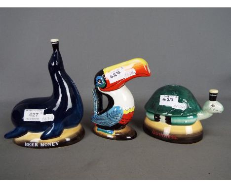 Breweriana - a Guinness ceramic jug in the form of a toucan and two money banks, one tortoise and one sea lion, largest appro
