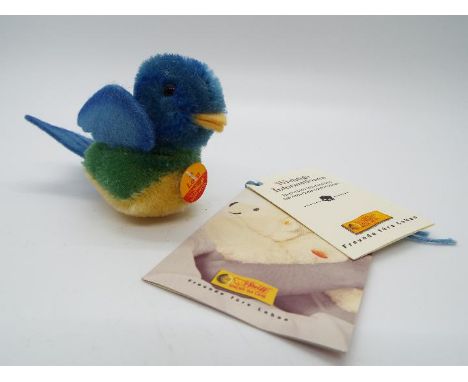 Steiff - a mohair Steiff blue bird entitled Lora with tag on breast, button and yellow label, 6 cm x 9.5 cm, tag/booklet #033