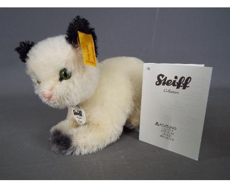 Steiff - a mohair Steiff Kitty Katze / cat with stitched nose, tag under chin, button and yellow label in ear, 10 cm x 15 cm,
