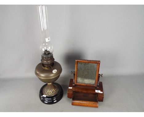 A Lampe National oil lamp and a good quality wood framed dressing table or shaving mirror. [2]