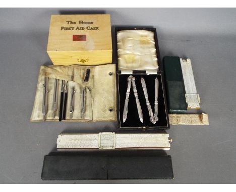 A vintage Boots Pure Drug Co Home First Aid Case (with contents), technical drawing set, slide rules and similar.